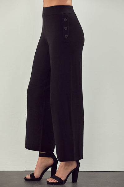 Collab Boutique black knit wide leg capri pants with ribbed elastic waist and button detail.