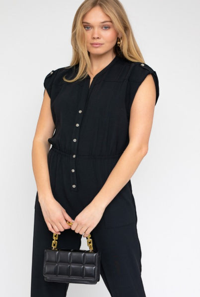 Collab Boutique black polyester dolman short sleeve button-up jumpsuit with elastic waist and pockets.