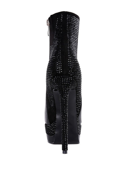 Collab Boutique black faux leather ankle boots with all-over diamante embellishments on the heel, platform, and back. Side zipper closure.