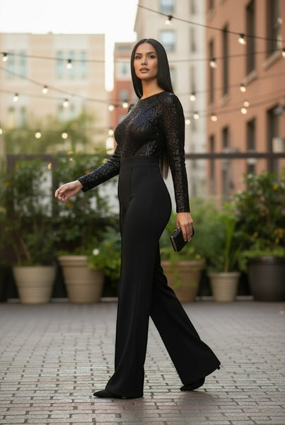 Collab Boutique black sequin jumpsuit with long sleeves, round neck, and flared legs. Model is 5'8, wearing size S.