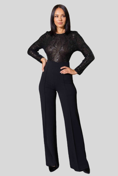Collab Boutique black sequin jumpsuit with long sleeves, round neck, and flared legs. Model is 5'8, wearing size S.