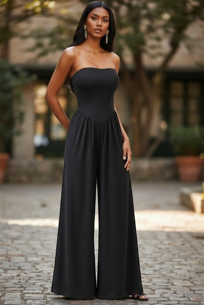 Collab Boutique black strapless wide leg jumpsuit with V-shape drop waist and pockets. Made of polyester and spandex.