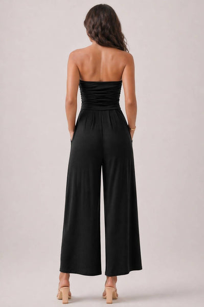 Collab Boutique black strapless tube top romper with shirring detail and palazzo pants with pockets. 96% Polyester, 4% Spandex.