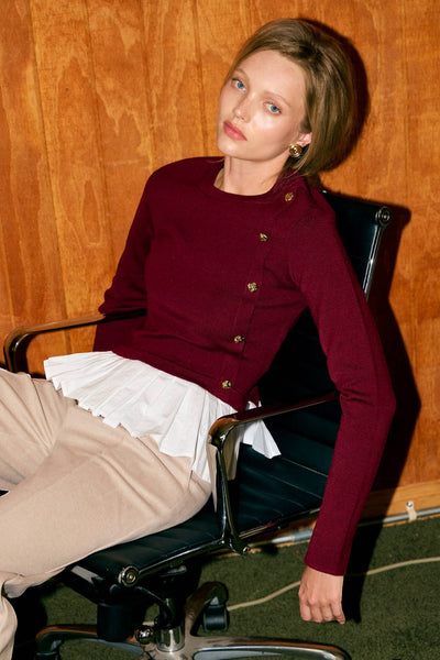Collab Boutique burgundy knit crew neck pullover top with white pleated hem and gold buttons, long sleeves, cotton-viscose blend.