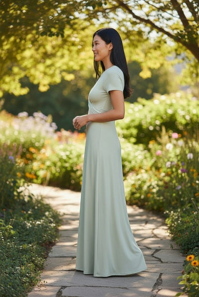 Collab Boutique light green rayon spandex crew neck maxi dress with short sleeves and twisted detail, worn by a woman outdoors.