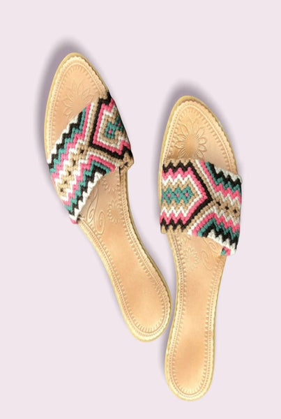 Collab Boutique colorful handwoven slide sandals with coral, tan, dark brown, green, and ivory geometric pattern. Leather insole.