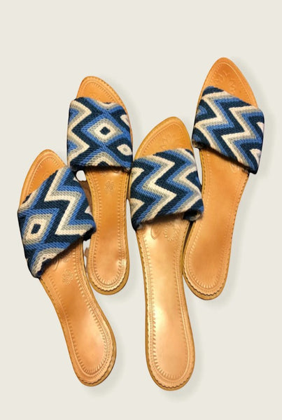 Collab Boutique handwoven slide sandals with blue, grey, and white geometric patterns and leather insoles.