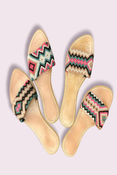 Collab Boutique colorful handwoven slide sandals with tan leather insole, featuring zigzag patterns in coral, teal, and ivory.