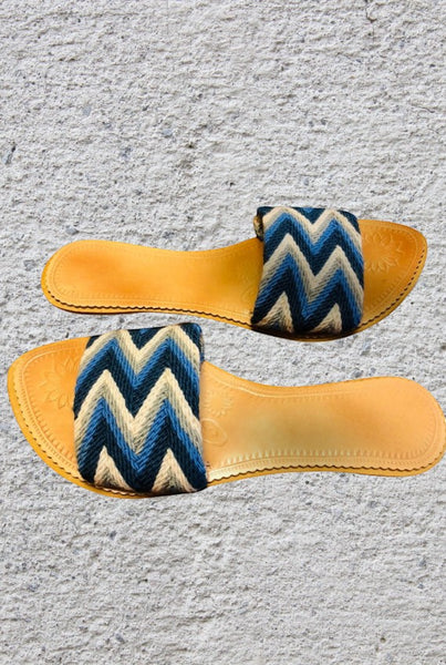 Collab Boutique colorful handwoven slide sandals with blue, grey, and white zig-zag pattern. Leather insole.