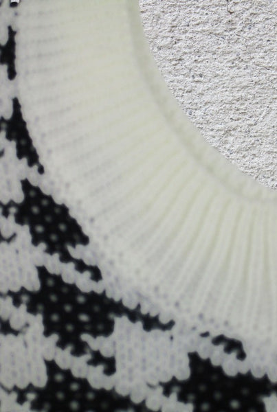 Collab Boutique black and white houndstooth knit V-neck vest. Ribbed neckline and hem.