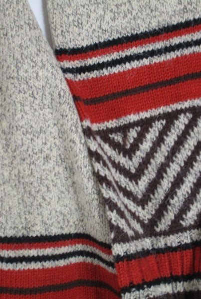 Collab Boutique tan, brown, auburn, and black knit sweater with geometric pattern and fringe detail on cuffs and hem.