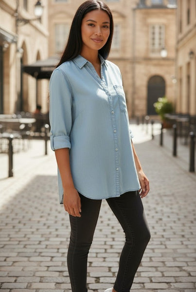 Collab Boutique light blue Tencel denim shirt with button-up front and roll-tab sleeves worn by a model.