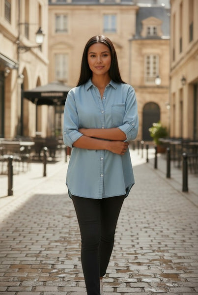 Collab Boutique light blue Tencel denim shirt with button-up front and roll-tab sleeves worn by a woman.