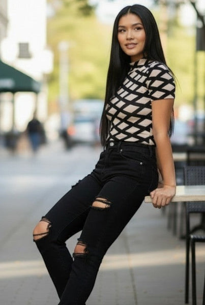 Collab Boutique mock neck short sleeve bodysuit with a geometric print in beige and black, made of nylon and spandex.