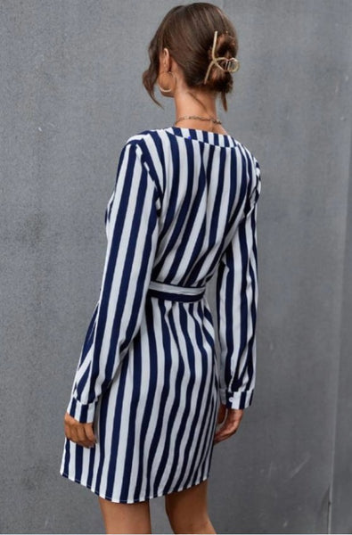 Collab Boutique navy and white vertical stripe long sleeve mini dress with detachable belt. Model is wearing a size S.