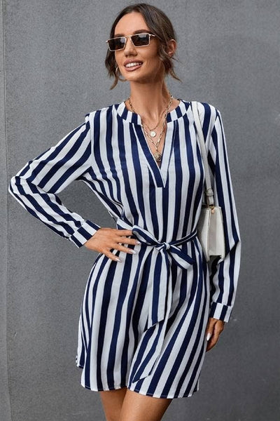 Collab Boutique navy and white striped long sleeve mini dress with V-neck and tie waist. Model wears size S.