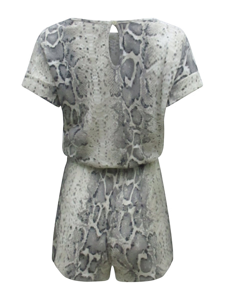 Collab Boutique neutral snake print lounge set with short sleeves and drawstring shorts. Made from polyester, rayon, and spandex.