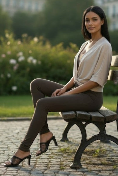 Collab Boutique taupe faux suede sleeveless bodysuit with a deep V-neck and knot detail, paired with dark brown leggings.