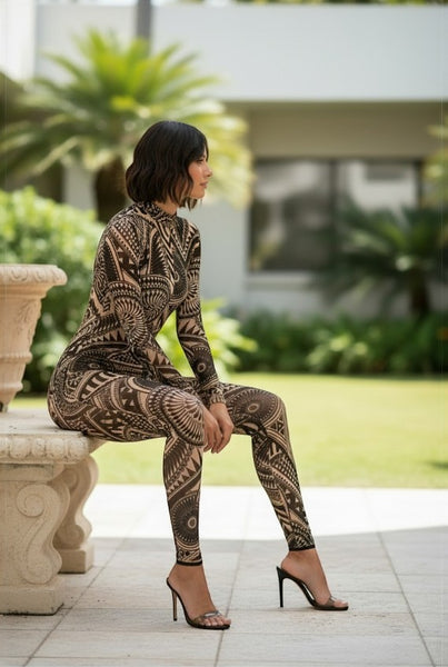 Collab Boutique black and tan tribal print mock neck long sleeve mesh jumpsuit on a woman sitting outdoors.