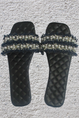Navy blue ruffle & pearl slides with transparent strap on a black quilt detail insole.