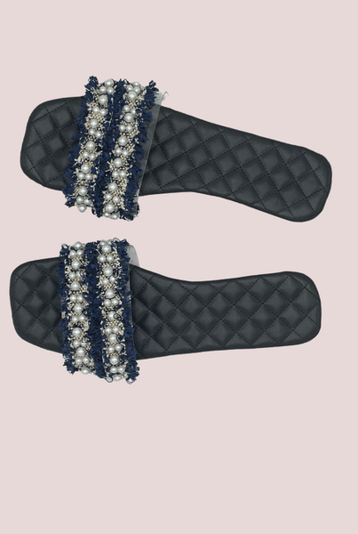 Navy blue ruffle & pearl slides with transparent strap on a black quilt detail insole.