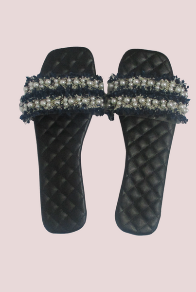 Navy blue ruffle & pearl slides with transparent strap on a black quilt detail insole.